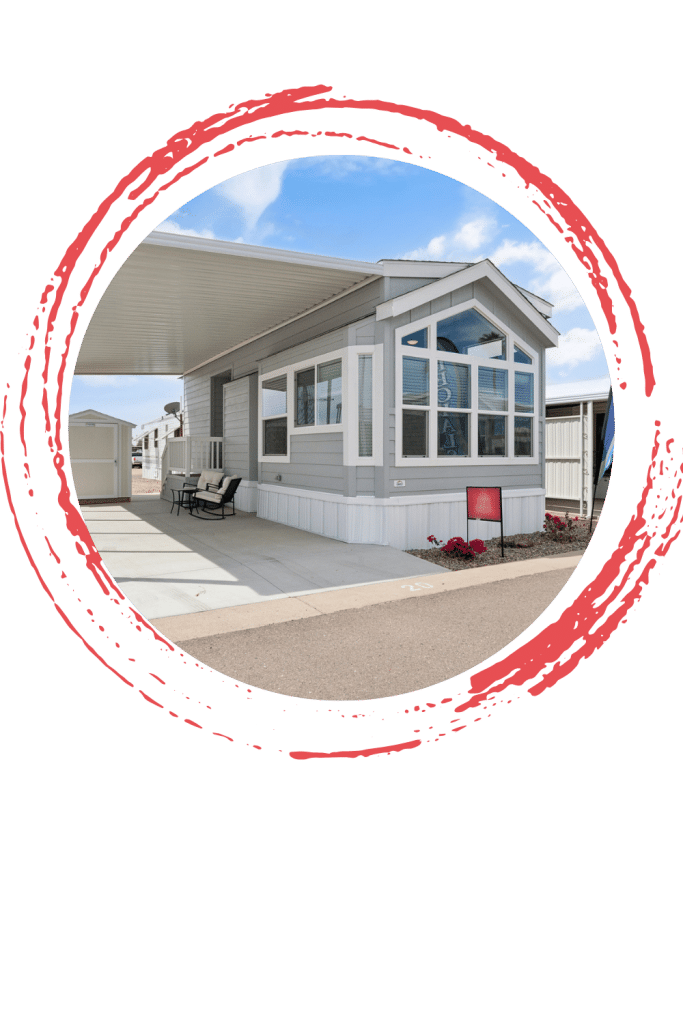A modern modular home with large windows, a covered patio, and a clean driveway under a clear blue sky in apache junction az